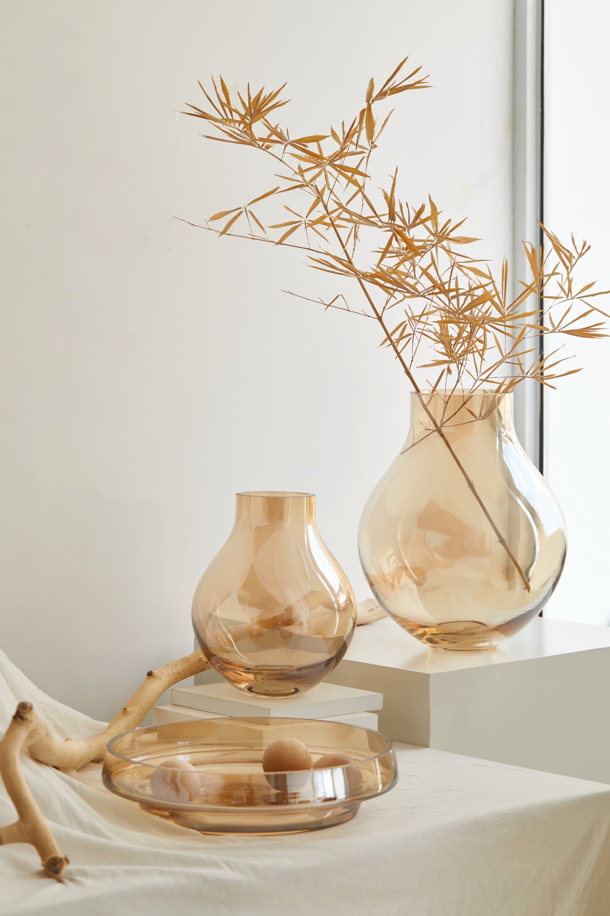 Envy glass vases in amber, styled with dried grasses